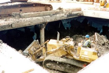 Excavation equipment being moved underneath the ground level slab